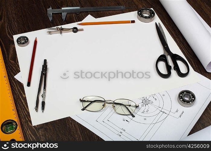 Tools and papers with sketches on the table