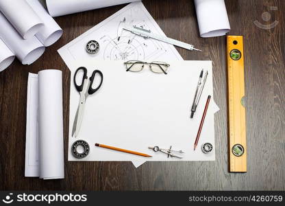 Tools and papers with sketches on the table