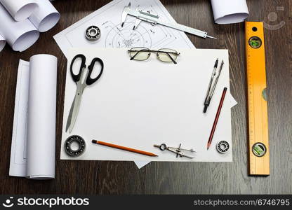 Tools and papers with sketches on the table