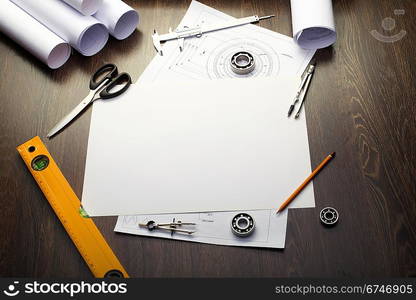 Tools and papers with sketches on the table