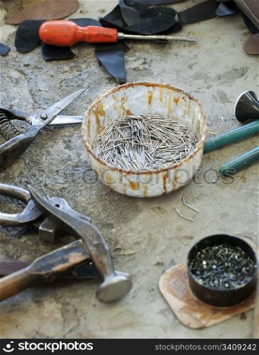 Tools for footwear and a bowl of nails