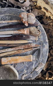 Tools for forming clay on  wooden background. 