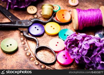 Tools for needlework and lilac branch. Set of sewing buttons,threads and scissors.Sewing accessories.