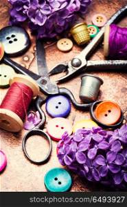 Tools for needlework and lilac branch. Set of sewing buttons,threads and scissors.Sewing accessories.
