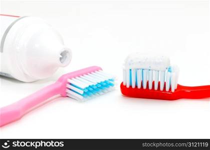 tooth brush and toothpaste on a white background
