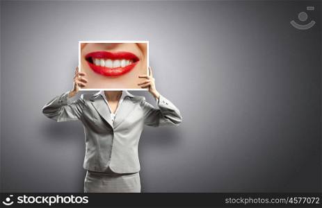Tooth care. Businesswoman holding banner with macro mouth image