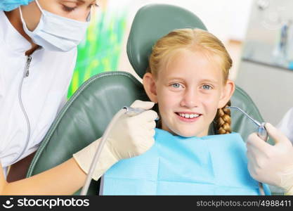 Tooth check. Cute smiling girl in at dentist sitting in armchair