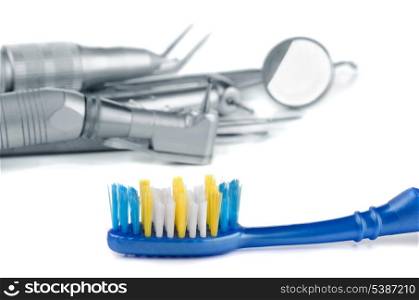 Toothbrush and dental tools on white background