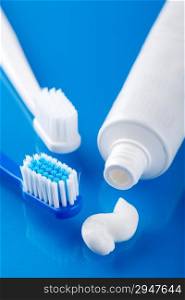 toothbrush and paste over blue