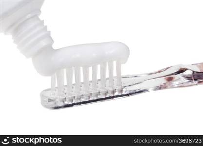 toothbrush and squeezed paste from tube close up isolated on white background