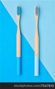Toothbrushes on blue background top view. Tooth care, dental hygiene and health concept.
