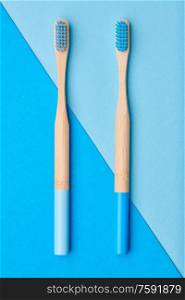 Toothbrushes on blue background top view. Tooth care, dental hygiene and health concept.
