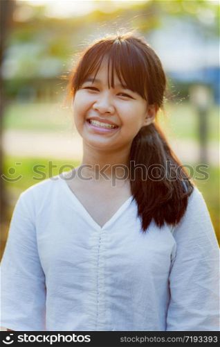 toothy smilife face of asian teenager standing outdoor. toothy smilife face of asian teenager standing outdoor
