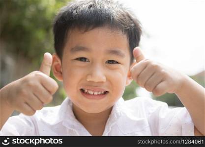 toothy smiling face of asian children happiness emotion