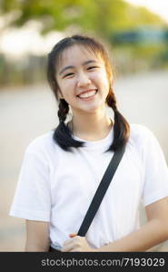 toothy smiling face of asian teenager standing outdoor