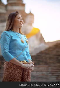 toothy smiling face of asian woman standing in ayuthaya world heritage site of unesco thailand