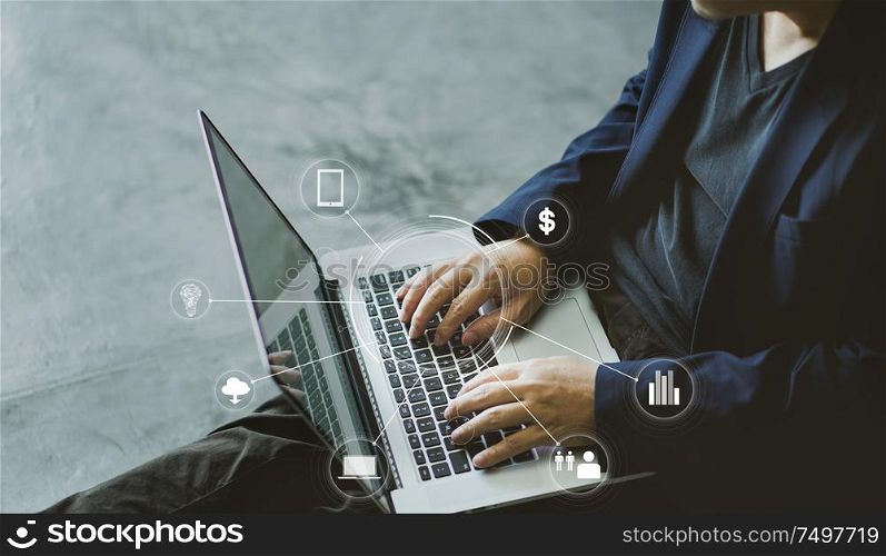 Top angle and close up view of businessman using the laptop with infographic effects of business application icon.