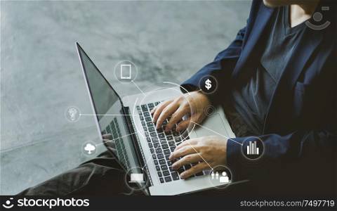 Top angle and close up view of businessman using the laptop with infographic effects of business application icon.