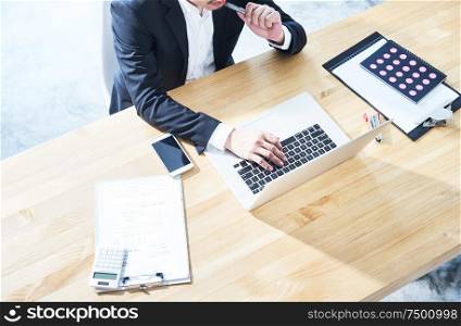 Top angle view of businessman using laptop computer to working at office .