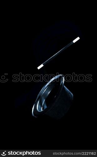 top black hat magic wand air against black background