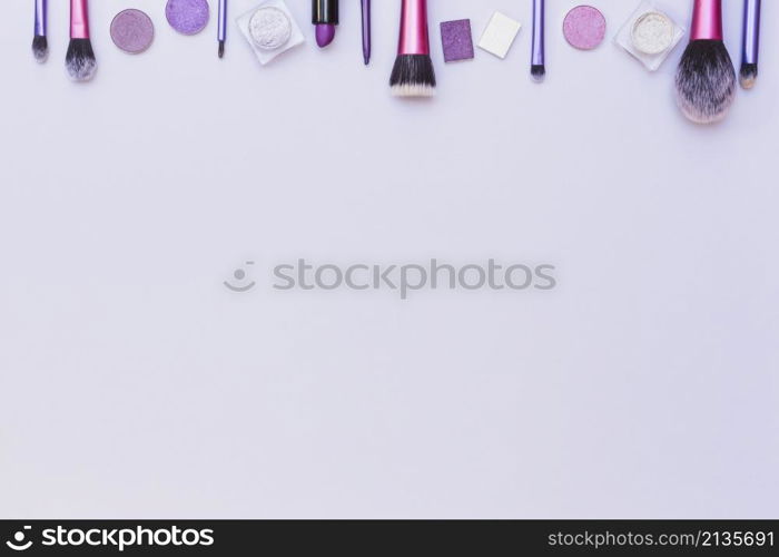 top border arranged with cosmetics product white background