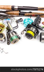top different fishing tackles - rod, reel, line and lures on white background