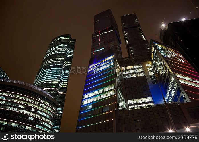 top floors of modern office building at night, skyscraper in moscow, foreshortening from below