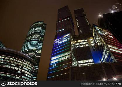 top floors of modern office building at night, skyscraper in moscow, foreshortening from below