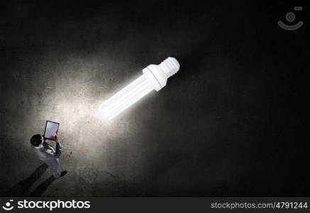 Top idea. Top view of businessman looking at bulb on floor