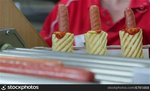 Top loading hotdogs in fast food diner close-up