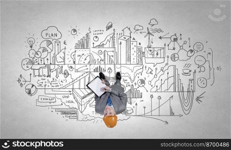 Top manager. Top view of a businessman with folder in hands and sketches on floor