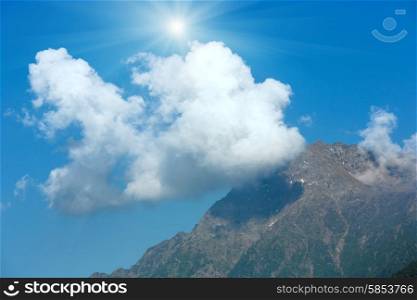 Top mountain sunshiny summer view with cloud in sky