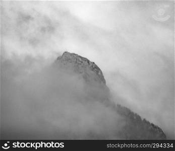 Top of a mountain in fog and clouds