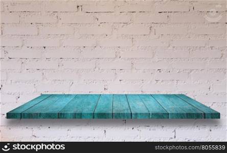 Top of blue wooden shelf with white brick wall decorated in coffee shop