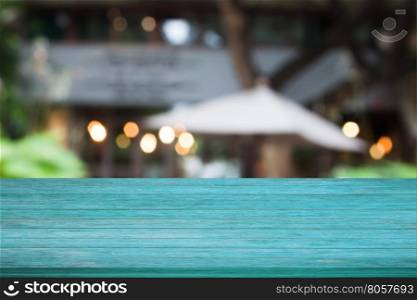 Top of blue wooden table with cafe blurred abstract background
