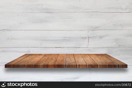 Top of brown wooden shelf with white wooden wall background. For product display