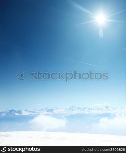 top of mountains sun in blue sky