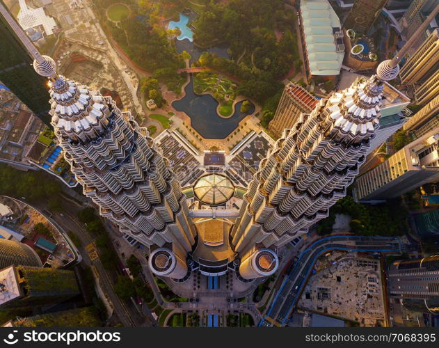 Top of Petronas Twin Towers. Aerial view of Kuala Lumpur Downtown, Malaysia. Financial district and business centers in smart urban city in Asia. Skyscraper and high-rise buildings at sunset.