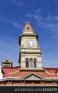 Top of Victoria City Hall and large clock with deep blue sky in background
