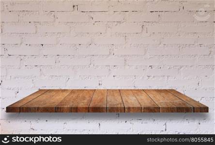 Top of wooden shelf with white brick wall decorated in coffee shop