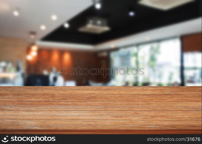 Top of wooden table with blurred cafe interior for background. product display template