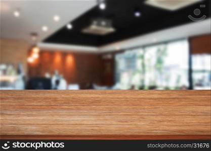 Top of wooden table with blurred cafe interior for background. product display template