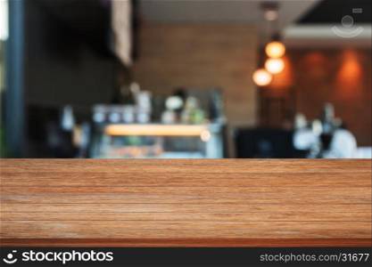 Top of wooden table with blurred coffee shop. product display template
