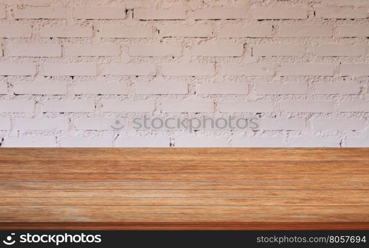 Top of wooden table with white brick wall decorated in coffee shop