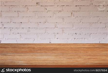 Top of wooden table with white brick wall decorated in coffee shop