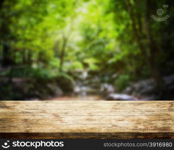 Top table wood and waterfall natural park background