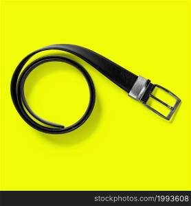 Top up up view black leather belt isolated on yellow background. suitable for your design project.