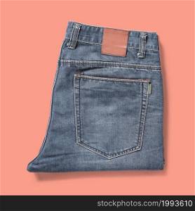 Top up up view blue jean folded isolated on pink background. suitable for your design project.
