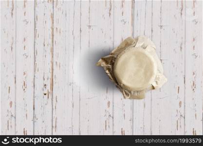 Top up up view blueberry jam jar isolated on white wooden background. suitable for your design project.