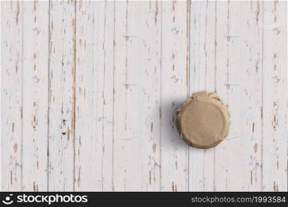 Top up up view yoghurt jar isolated on white wooden background. suitable for your design project.
